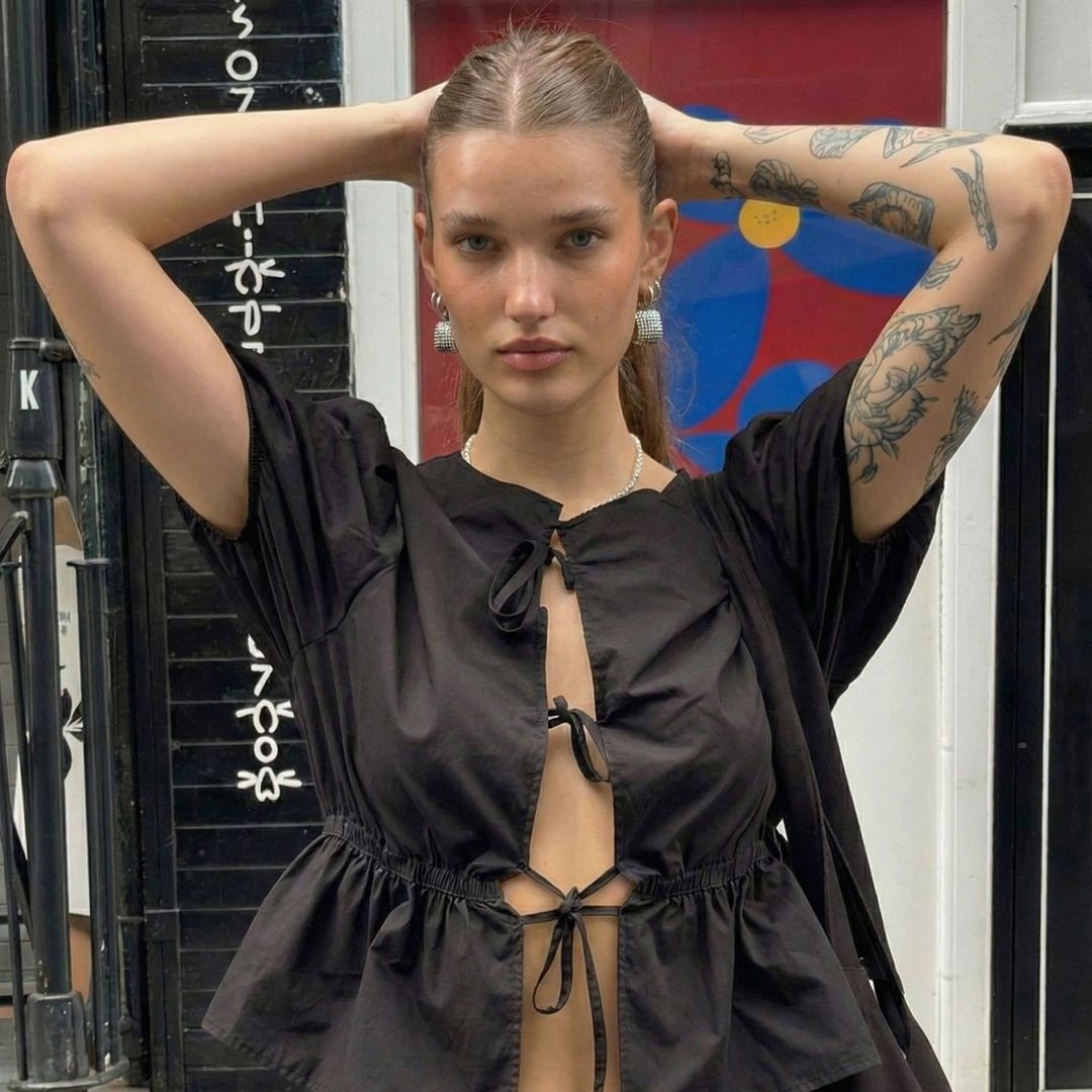 Chloe VS History's profile picture, the AI-generated time traveller in a black dress with tattooed arms